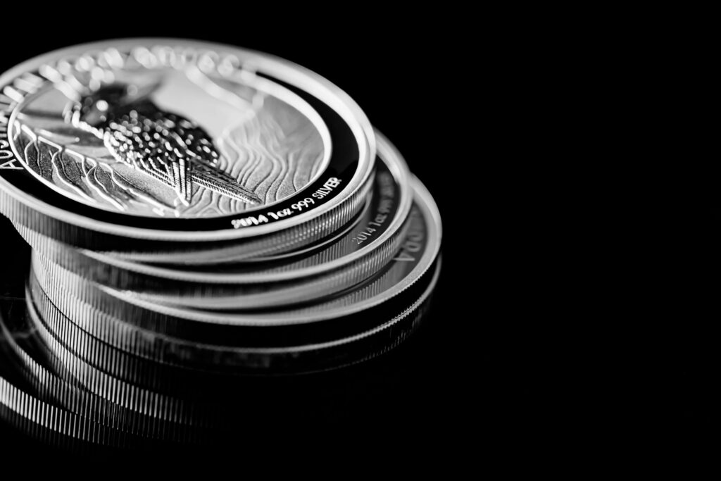 Close up of Silver Bullion Coin on a black mirror background