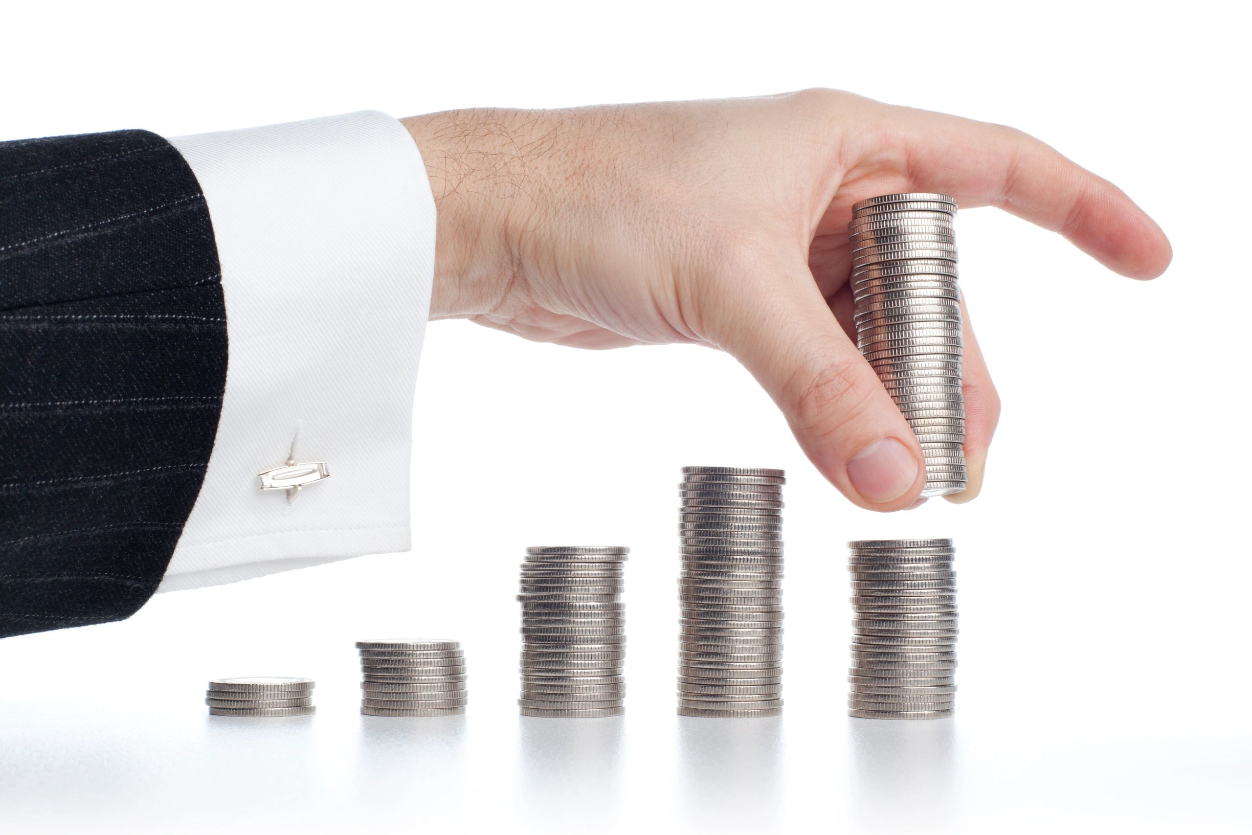 Silver coins stacked on a desk to suggest careful investing